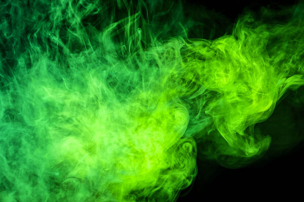 Cloud of green smoke on a black isolated background. Background from the smoke of vap