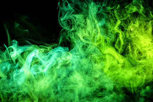 Thick colorful green smoke on a black isolated background. Background from the smoke of vape. Mocap for cool t-shirt