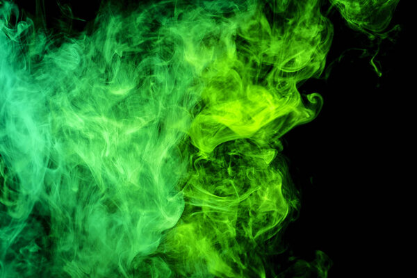 Dense green smoke on a black isolated background. Background of smoke vap
