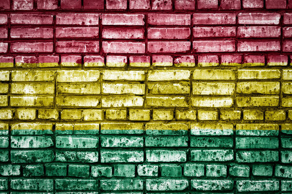 National flag of Bolivia on a brick background. Concept image for Bolivia: language , people and culture.