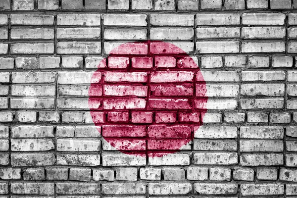 National flag of Japan on a brick background. Concept image for Japan: language , people and culture.