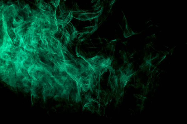 Thick colorful green smoke on a black isolated background. Background from the smoke of vape. Mocap for cool t-shirt