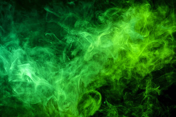 Green cloud of smoke of black isolated background. Background from the smoke of vap