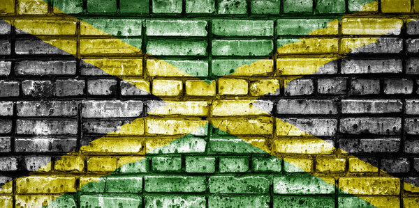 National flag of Jamaica on a brick background. Concept image for Jamaica: language , people and culture.