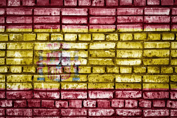 National flag of Spain on a brick background. Concept image for Spain : language , people and culture.