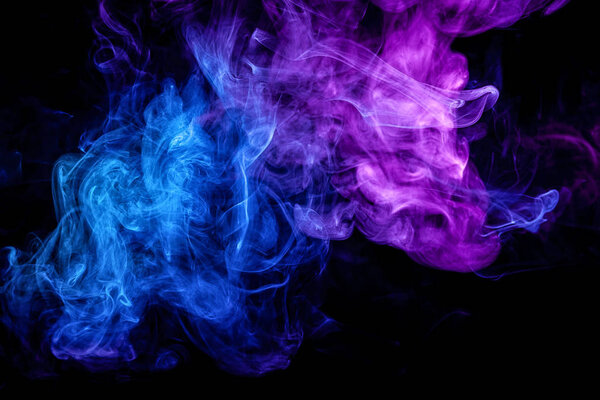 Close up swirling purple and blue smoke on black isolated backgroun