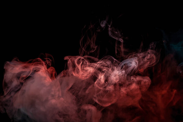 Red and blue cloud of smoke of black isolated background. Background from the smoke of vap