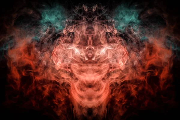 Fantasy print for clothes: t-shirts, sweatshirts.  Colorful blue and red smoke in the form of a skull, monster, dragon on a black isolated background. Background from the smoke of vap