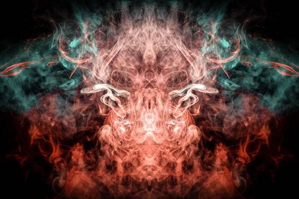 Fantasy print for clothes: t-shirts, sweatshirts.  Colorful blue and red smoke in the form of a skull, monster, dragon on a black isolated background. Background from the smoke of vap