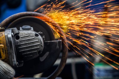 Close-up taşıyan metal El Daire testere ile parlak yanıp söner bir oto tamircisi için arka plan araçları farklı yönlerde uçan testere bir adam. Otomatik mekanik çalışmalarını.