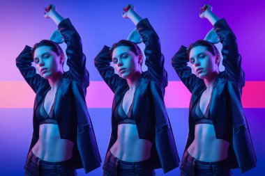 Studio poz yüksek moda model kadın moda giysileri renkli parlak neon uv ışıklarda, mavi ve pembe. Moda kavramı ve Zine kültür