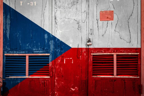 Close-up of old warehouse gate with national flag of Czech Republic. Concept of Czech Republic export-import, storage of goods and national delivery of goods. Flag in grunge style