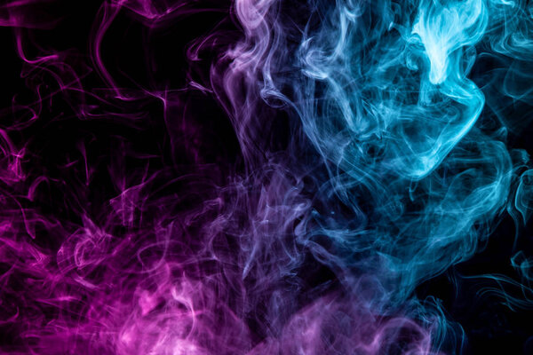 Colorful pink and blue smoke on a black isolated background. Background from the smoke of vape