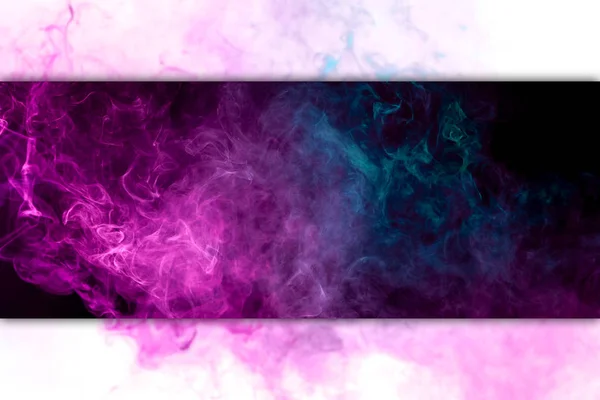 Pink and blue cloud of smoke of  black isolated background. Background from the smoke of vap