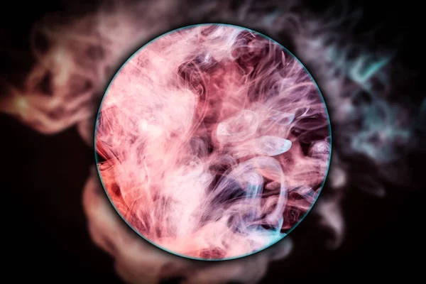 Close-up  blue and red bomb smoke  blown under a magnifying glass on black isolated  background