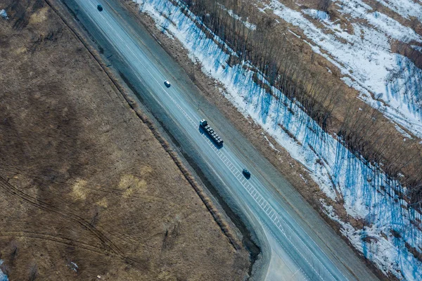 Helicopter drone shot. Aerial photography of a modern roads with car, track in winter.