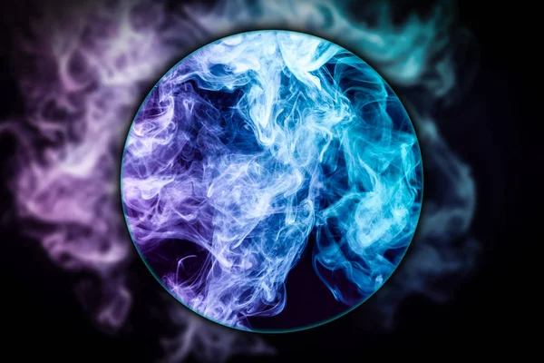 Close-up pink and blue cloud of smoke   blown under a magnifying glass on  black isolated background. Background from the smoke of vap