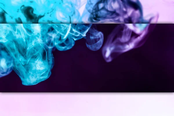 Frozen abstract movement of  explosion pink and blue  smoke multiple colors on black and white background. Background from the smoke of vape