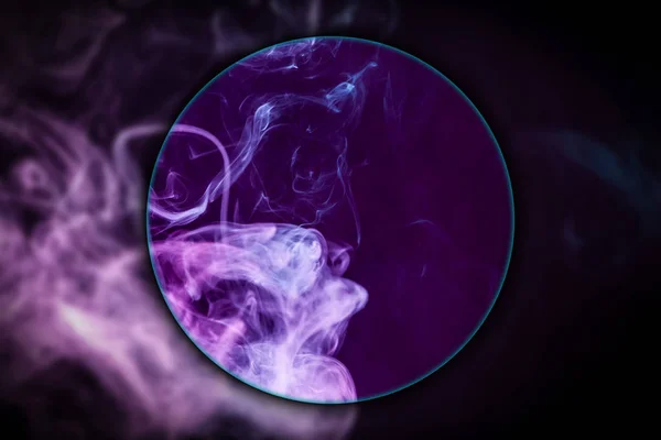 Close-up pink and blue cloud of smoke   blown under a magnifying glass on  black isolated background. Background from the smoke of vap