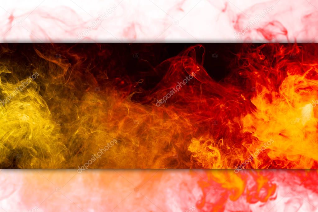 Frozen abstract movement of  explosion smoke multiple colors yellow and orange  on black and white  background. Background from the smoke of vape