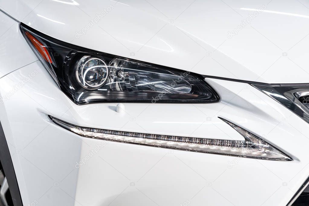 Novosibirsk, Russia - May 06, 2019:   Lexus NX 200,close-up of the headlights. Photography of a modern car on a parking in Novosibirs