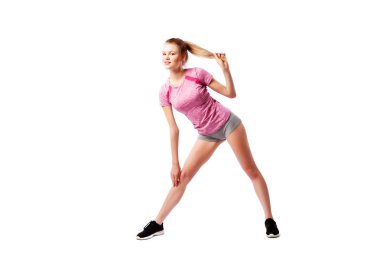 Beyaz arka plan, fitness konsepti üzerinde spor egzersizleri. Rahat spor (şort ve üst) genç bir kadın büyüleyici gülümsüyor ve izole beyaz bir arka plan üzerinde bacakları ile yanlara geniş lunges yapıyor.