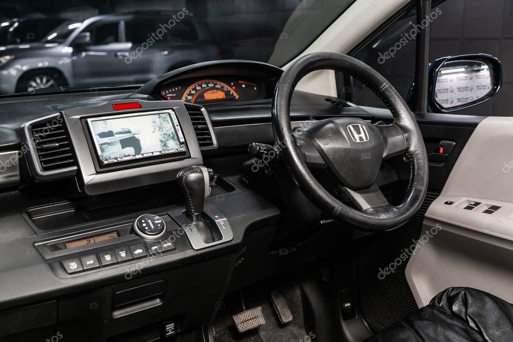 Novosibirsk, Russia - May 28, 2019:  Honda Freed, close-up of the dashboard, speedometer, tachometer , black seats and steering wheel.Photography of a modern car on a parking in Novosibirs