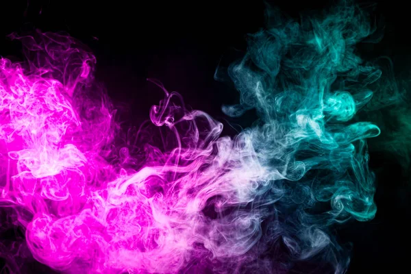 Pink and blue cloud of smoke of  black isolated background. Background from the smoke of vap