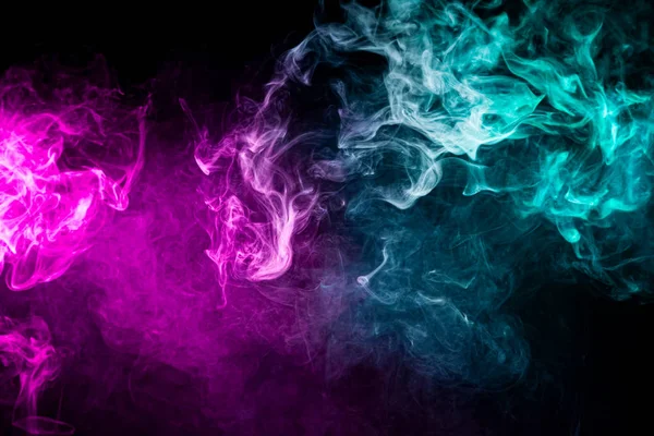 Pink and blue cloud of smoke of  black isolated background. Background from the smoke of vap