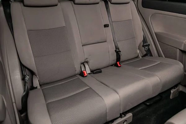 Novosibirsk, Russia   June 11, 2019:  Volkswagen Golf +, close-up of the gray rear seats with seats belt. modern car interio