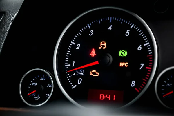 Interior view of car with black salon. Modern luxury prestige car interior: speedometer, dashboard and tachometer  with white backlight and other buttons. Soft focus