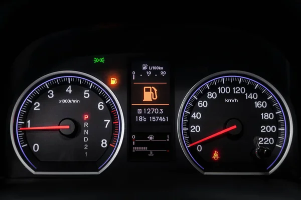 Interior view of car with black salon. Modern luxury prestige car interior: speedometer, dashboard and tachometer  with white backlight and other buttons.Soft focus