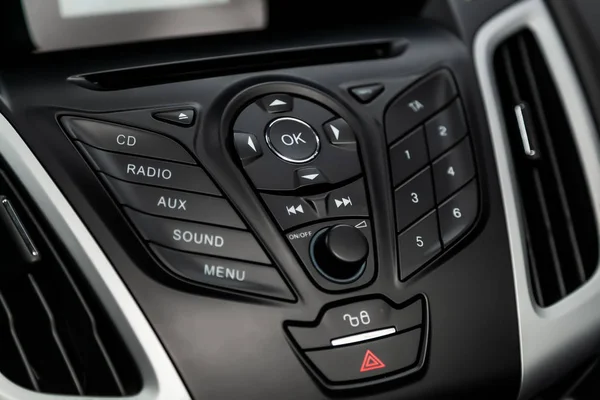 Car control panel of audio player and other devices.A shallow depth of field close up of the control panel of a car. Parts shown are the CD player and radio controller, as well as the air conditioning control dials and button.