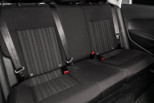 Close-up of the black rear seats with seats belt. modern car interio