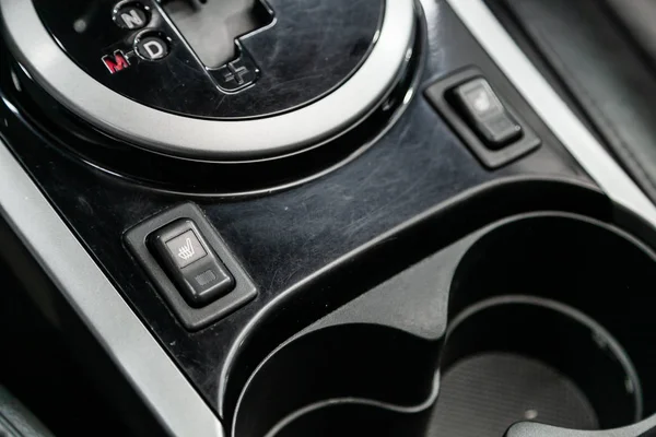 Close-up on the seat heating  control buttons,  automatic adjust level dashboard. modern car interior: parts, buttons, knob
