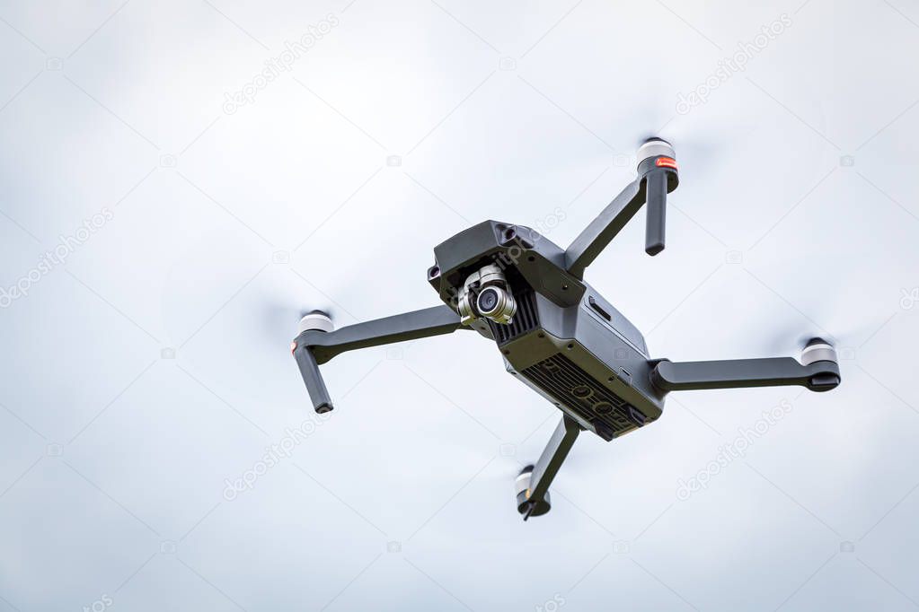 Close up of the dron helicopter with a camera. Quadcopter isolated on  sky background