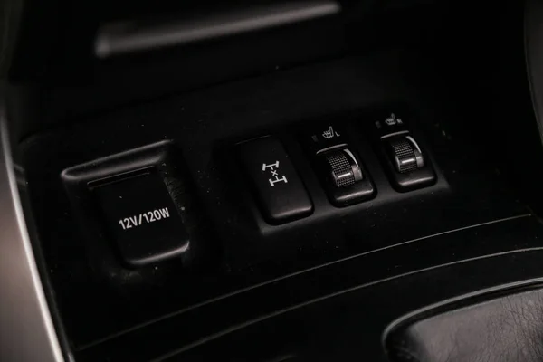 Close-up of seat heating, charging in the car, off road  suspension control buttons. modern car interior: parts, buttons, knob