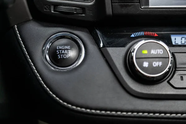 Close-up of start stop engine  button. modern car interior: parts, buttons, knobs. Soft focu