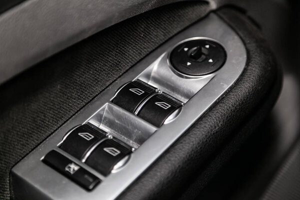 Новосибирск, Россия 1 августа 2019 года: Ford Focus, крупным планом боковые дверные кнопки: кнопки регулировки окон, дверной замок. современный интерьер автомобиля: детали, кнопки, ручка
 