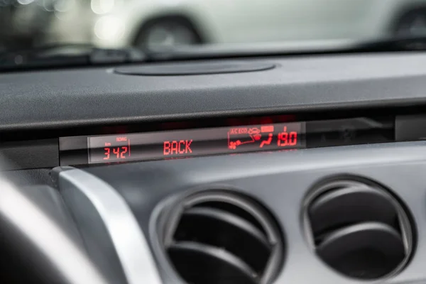 close-up of the dashboard with information about temperature, radio, clock and other. modern car interio