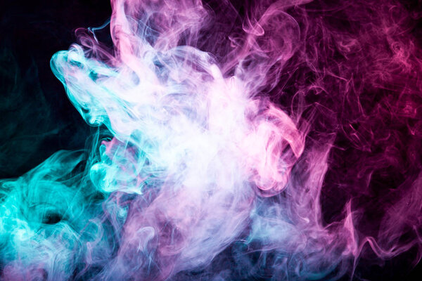 Abstract artwork. Trendy wallpaper. Frozen abstract movement of explosion smoke multiple colors on black background.