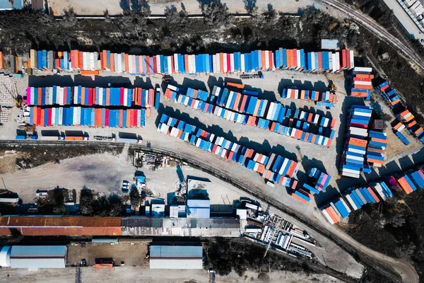 Top view of logistics center, a large number of containers of different colors for storing goods. The concept of storage of goods by importers, exporters, wholesalers, transport enterprises, customs