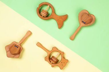 Çok renkli düz çevre dostu ahşap oyuncaklar ile yatıyordu, bir kalp şeklinde çıngıraklar, balık, yıldız, ayı. Üst görünüm, kopyalama alanı, maket, öğrenme ve eğlence çocuklar için şablon