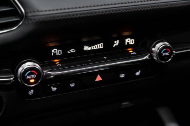 Novosibirsk, Russia  September 30, 2019:  Mazda 3, Car, vehicle interior with visible climate controls, adjustment of the fragment of instrument panel 
