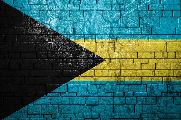 National flag of Bahamas on brick  wall background.The concept of national pride and symbol of the country. Flag  banner on  stone texture background.