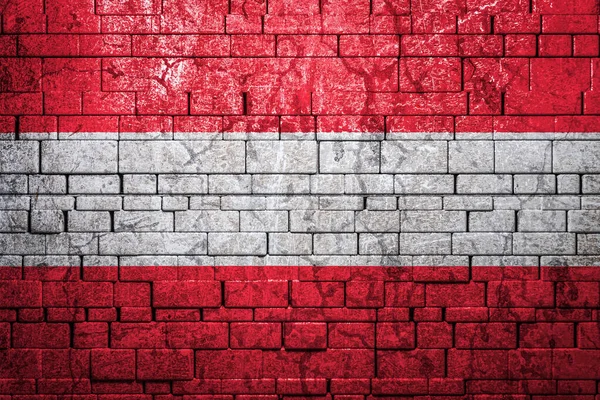 National flag of Austria on brick  wall background.The concept of national pride and symbol of the country. Flag  banner on  stone texture background.