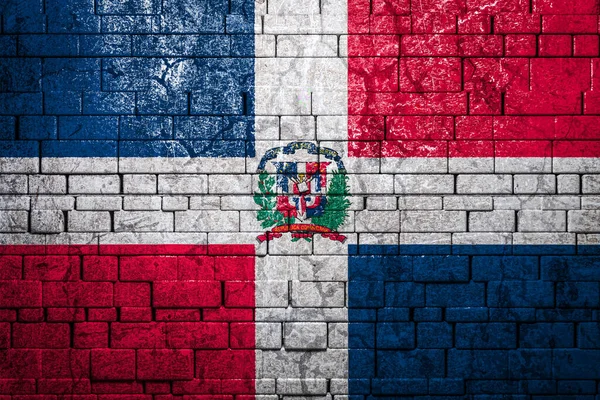 National flag of Dominicana on brick  wall background.The concept of national pride and symbol of the country. Flag  banner on  stone texture background.