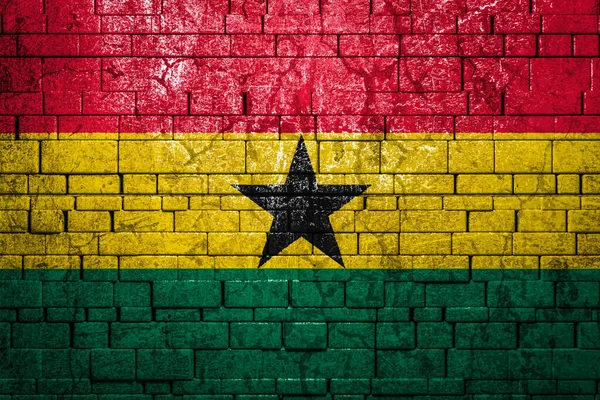 National flag of Ghana on brick  wall background.The concept of national pride and symbol of the country. Flag  banner on  stone texture background.