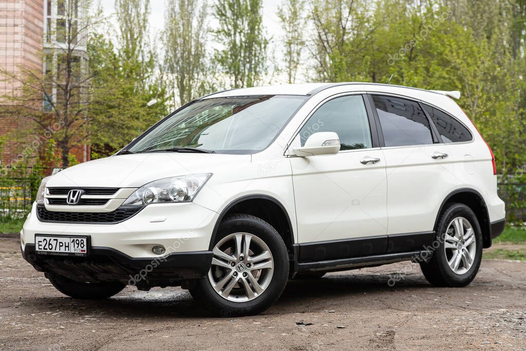 Novosibirsk/ Russia  May 02, 2020: white Honda CR-V, popular jeep  car parked outdoors on a warm summer day, front view