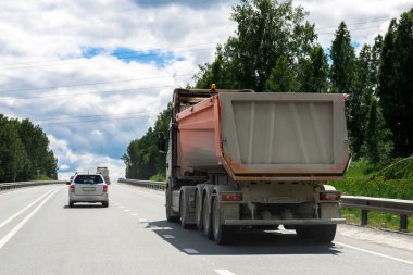 Kirli bir kamyon otoban boyunca başka bir ülkeye mal götürüyor. İhracat-ithalat, ulaşım, malların ulusal teslimatı 